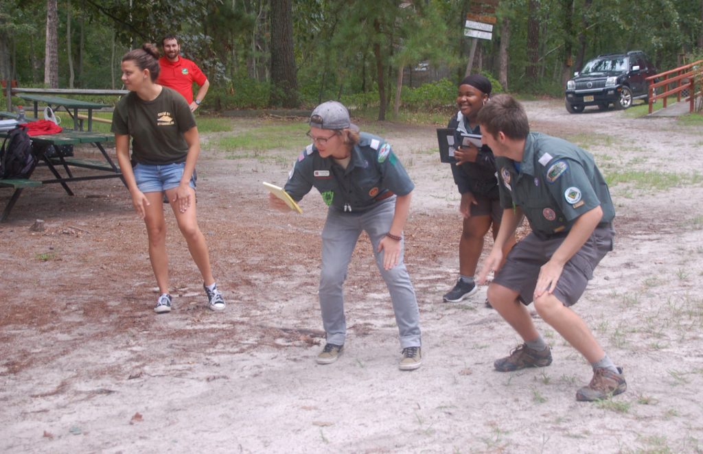 Venturers lead a group song at an outdoor event